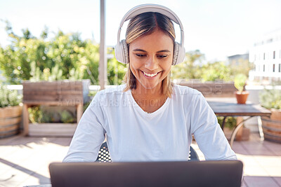 Buy stock photo Woman, laptop and headphones, student and education with smile, study and online course, elearning and university. Female at outdoor cafe, writing thesis and listen to music with research for paper