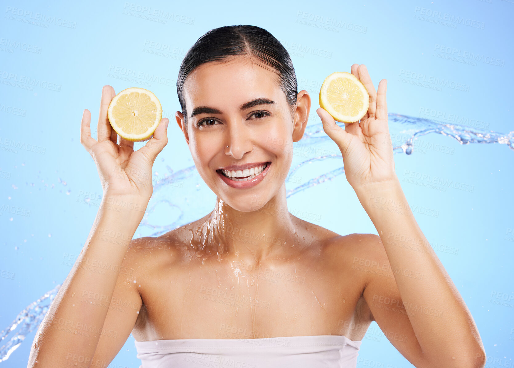 Buy stock photo Health, lemon and water splash with portrait of woman in studio for natural cosmetics, nutrition and detox. Glow, fruits and hydration with female on blue background for diet, clean face and skincare