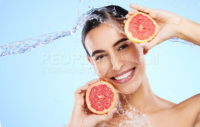 Buy stock photo Grapefruit, water or happy girl portrait with beauty in studio on blue background for healthcare or natural diet. Smile, wellness or healthy model face with fruits or vitamin c for skincare or detox