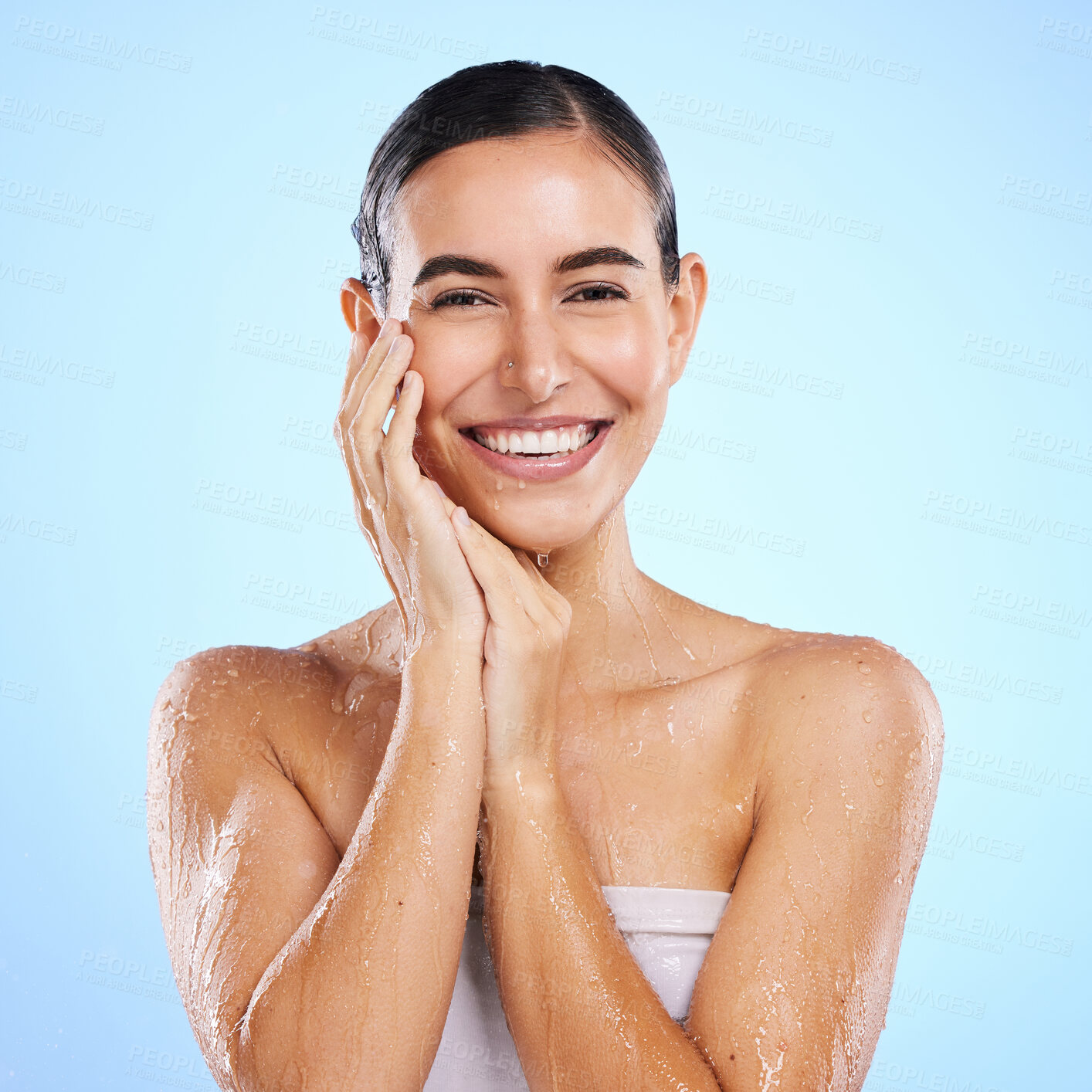 Buy stock photo Happy woman, shower and portrait smile for skincare hygiene, dermatology or wellness against a blue studio background. Calm female face in natural beauty cosmetics, water drops or facial treatment