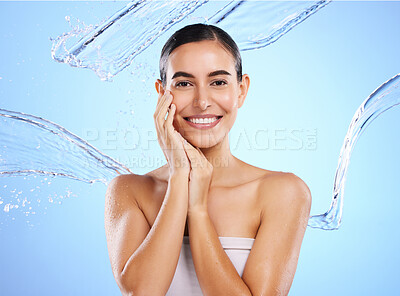 Buy stock photo Happy woman, water splash and portrait smile for skincare moisturizer, product or cream against a blue studio background. Calm female face in natural beauty cosmetics, hygiene or facial treatment