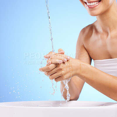 Buy stock photo Water, happy woman or washing hands in studio on blue background for wellness or skincare hydration. Healthcare, mouth smile zoom or girl cleaning with liquid splash in hygiene or bacteria prevention