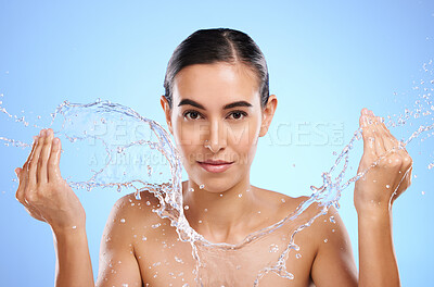 Buy stock photo Water splash, portrait or woman with face wash for skincare, fresh body hygiene on blue background in studio. Girl model with clean hands or wellness washing in beauty grooming for facial treatment 