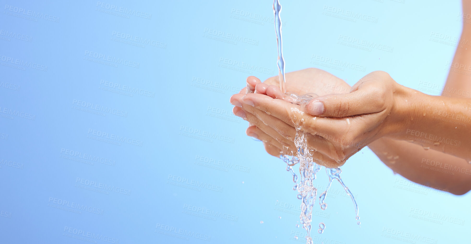 Buy stock photo Water splash, woman or cleaning hands in studio on blue background for wellness or skincare hydration. Mockup space banner, palm or girl with liquid splash hand wash in hygiene or bacteria prevention