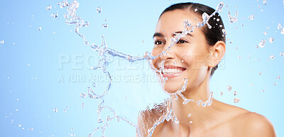 Buy stock photo Water splash, smile or happy girl with face wash for skincare or hygiene on blue background in studio. Banner, mockup or woman with wellness cleaning or washing in beauty grooming or facial treatment