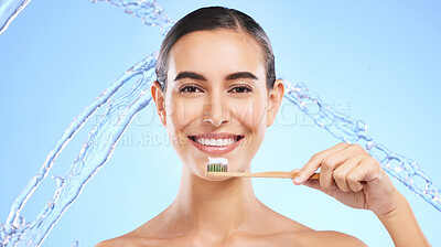 Buy stock photo Portrait, water splash or happy girl brushing teeth with product for healthy oral or dental hygiene in studio. Face, smile beauty or woman model cleaning mouth with a natural bamboo wooden toothbrush