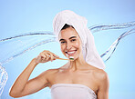 Woman, water splash and toothbrush for teeth, dental care or skincare hygiene against blue studio background. Portrait of happy female smile in tooth whitening, oral or mouth treatment for healthcare