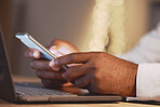 Business man, hands and phone by a laptop typing a message for work networking. Hand closeup, bokeh and online management of a employee working and planning a job schedule with technology and email