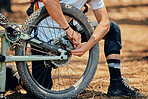 Maintenance, race and a man with a bicycle in nature for cycling, construction and building a bike. Fitness, sports and a biker with transportation. fixing a gear and wheels during cardio in a park