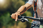 Mountain bike, cyclist hand and brake outdoor in nature in sunshine for safety, extreme sport or lens flare. Man, bicycle and marathon challenge for fast workout, training or exercise for summer race