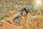 Extreme sports, man and cycling on bicycle in the countryside for fitness, stunt and freedom. Nature, biking and sporty male cyclist training, practice and speed, action and free on Mexico dirt road