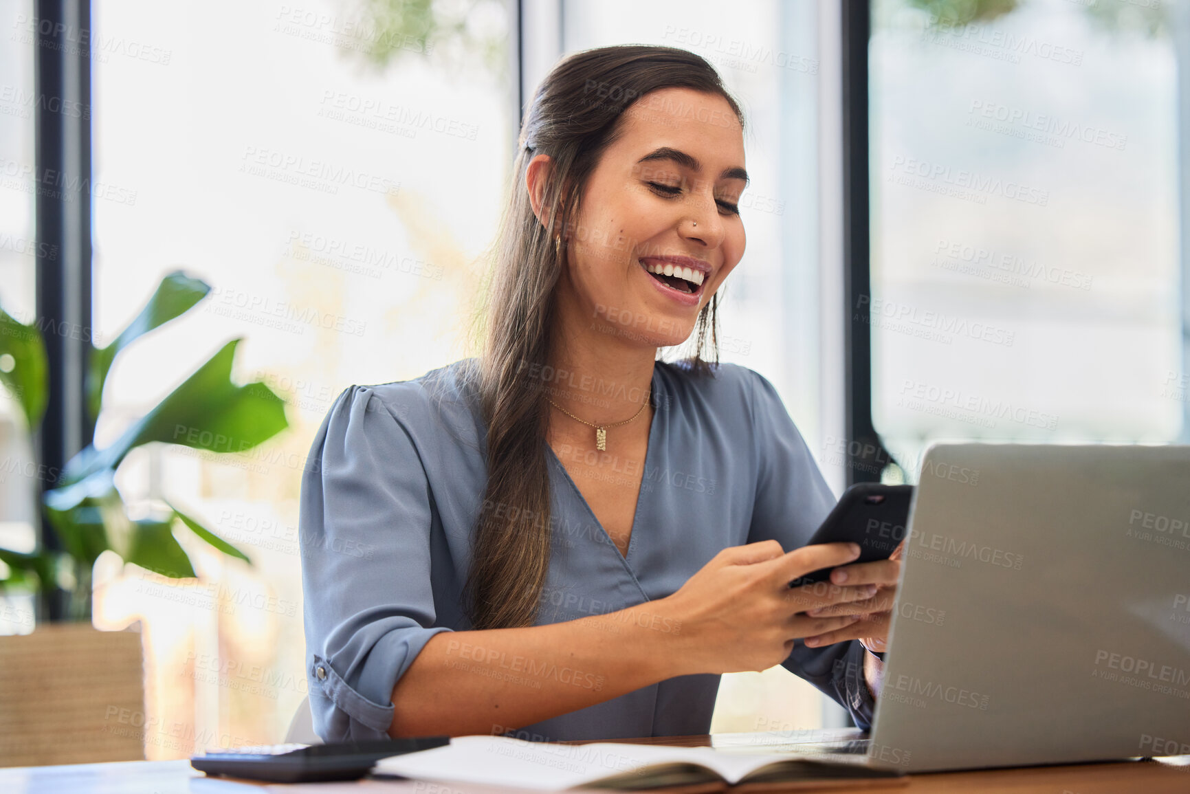 Buy stock photo Phone, happy and business woman laughing while texting in office, typing and reading meme while working on a laptop. Funny, online and social media joke by lady employee enjoying humor, break or text