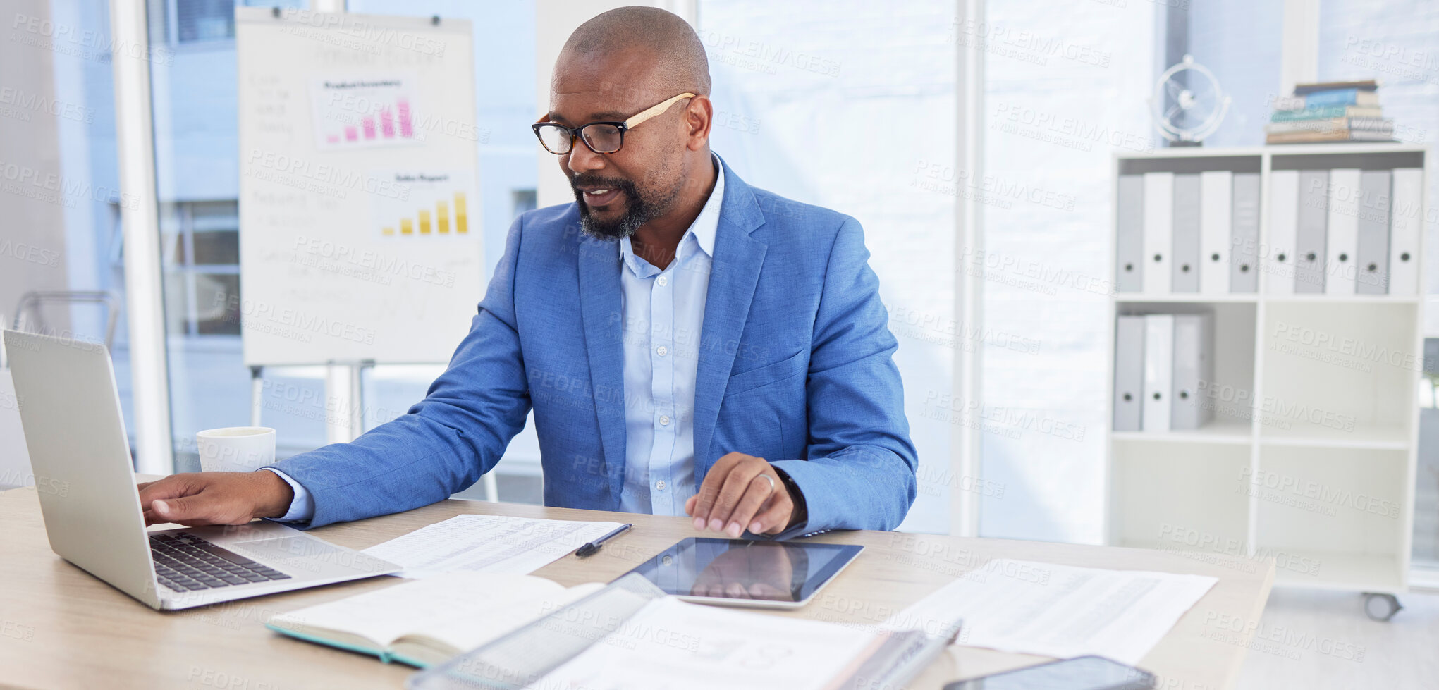 Buy stock photo Black man, business and laptop for corporate planning, strategy or communication at the office desk. African American male CEO working on computer for company statistics, marketing or schedule tasks
