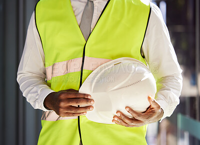 Buy stock photo Property development, architect and hands with a safety helmet for construction and engineering. Building, black man and business developer ready for real estate and infrastructure renovation