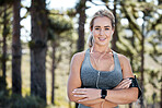Fitness, woman and portrait smile with arms crossed for confidence in exercise, workout or training in nature. Happy, fit and confident sports female with earphones listening to music in the forest