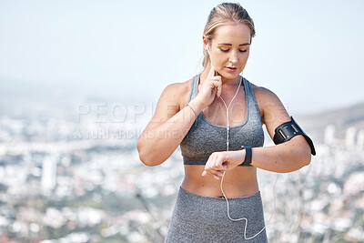 Buy stock photo Fitness, woman and smart watch checking heart rate, pulse or tracking running performance with earphones in nature. Active and fit female runner listening to music and monitoring healthy wellness