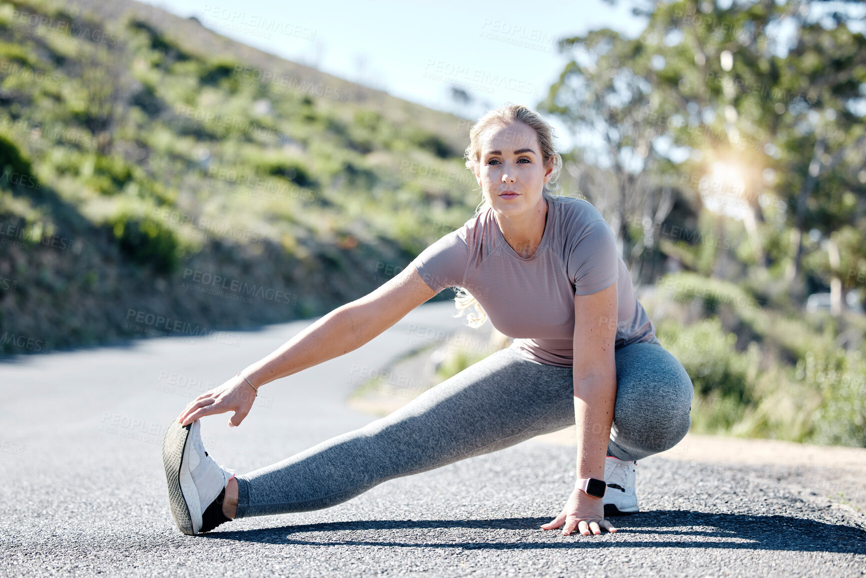 Buy stock photo Fitness, woman and stretching legs on road for exercise, start or workout in nature. Serious, determined and fit sporty female in warm up leg stretch getting ready for training or running outdoors