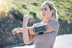Fitness, serious woman and stretching arms with earphones for exercise, start or workout in nature. Determined and fit female in focus listening to music in warm up arm stretch for training outdoors