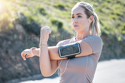 Buy stock photo Fitness, serious woman and stretching arms with music earphones for exercise, start or workout in nature. Determined and fit female in focus listening to radio in arms warm up for training outdoors
