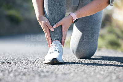 Running, fitness and ankle injury with a woman on the street during a cardio or endurance workout. Medical, pain and accident with a female runner outdoor on a road for health, sports or training