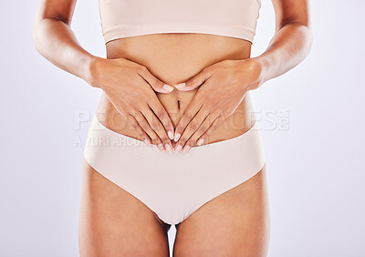 Buy stock photo Hands, stomach and belly of a woman natural model with smooth skin isolated in a studio white background. Weight loss, diet and female touch abdomen for healthcare, fitness and nutrition