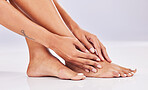 Closeup, skincare and legs with beauty, dermatology and wellness against a studio background. Feet, female and woman with hair removal, salon treatment and luxury with grooming, smooth and soft skin