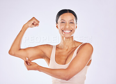 Beautiful strong muscular woman flexing her biceps and arm muscles