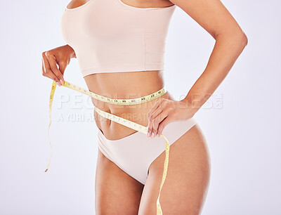 Buy stock photo Health, stomach and tape measure woman waist for diet in studio for healthy lifestyle, weight loss or fitness. Female on a white background for wellness and self care motivation or healthcare goals