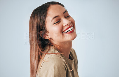 Buy stock photo Woman, laughing and happiness of a gen z female in a studio with gray background. Isolated, happy and smile from a young person feeling carefree, youth and confidence with laughter from funny joke