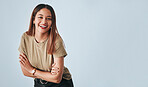 Portrait, mockup and laughter with an arms crossed woman in studio having fun on a gray background. Comic, comedy and humor with an attractive young female standing indoor feeling playful or carefree