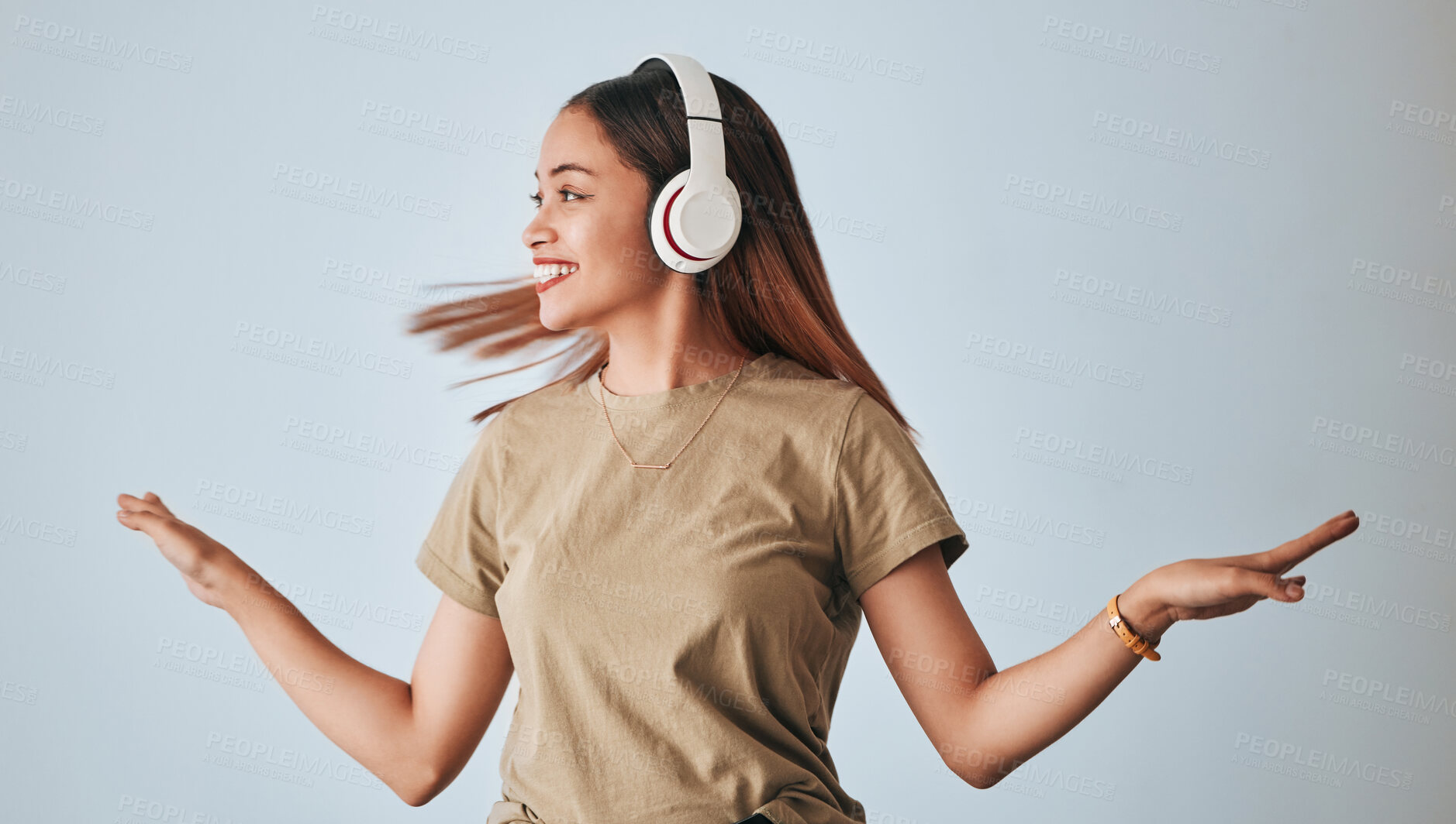 Buy stock photo Woman, music headphones and dancing in studio while happy, excited and positive. Female model on white background to dance with hands, fun and smile with energy and listening to audio or radio