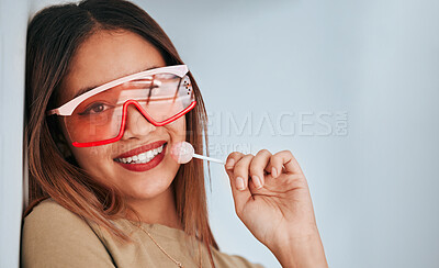 Buy stock photo Lollipop, woman and smile with makeup, cosmetics and gen z style eating a sweet candy. Lips, young person and studio background with mockup and a female model with sweets and cool fashion sunglasses