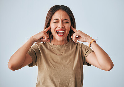 Woman, frustrated and fingers in ears, studio background and shouting with anger, annoyed or problem. Student girl, anxiety and model for mental health, angry face and not listening by grey backdrop