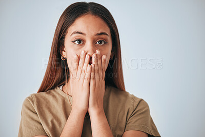 Buy stock photo Portrait, woman and surprise in a studio with a female cover mouth from shock. Isolated, grey background and hands on a face of a young person model with wow, worry and alert reaction from secret