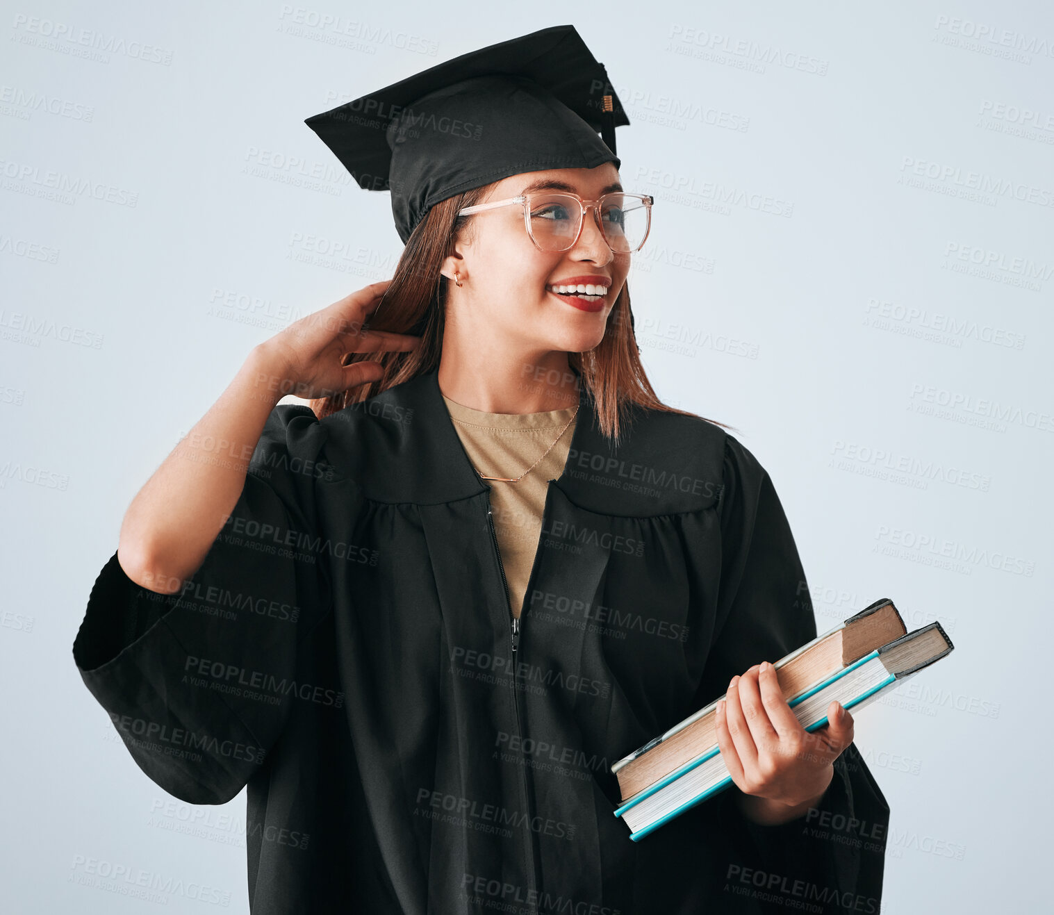 Buy stock photo Graduation cap, books and woman isolated on studio background for happy education, college or scholarship success. Biracial university student or graduate with reading knowledge and learning goals