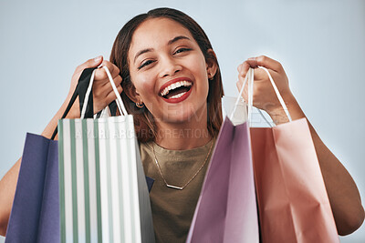 Buy stock photo Portrait, happy woman and shopping bag isolated on studio background wealth, financial freedom or sales promotion. Retail, fashion and beauty face of biracial person or customer with paper bags offer