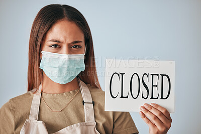 Buy stock photo Covid, female business owner and closed sign in face mask in studio portrait for announcement, board or worry for future of shop. Entrepreneurship, woman or stress with poster, bankrupt or management