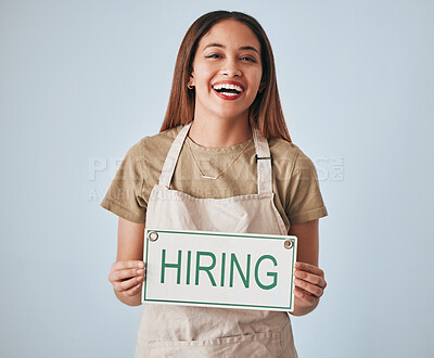 Buy stock photo Happy woman, portrait and hiring sign for small business recruitment, career or job opportunity against a gray studio background. Female entrepreneur with apron holding billboard or poster for hire