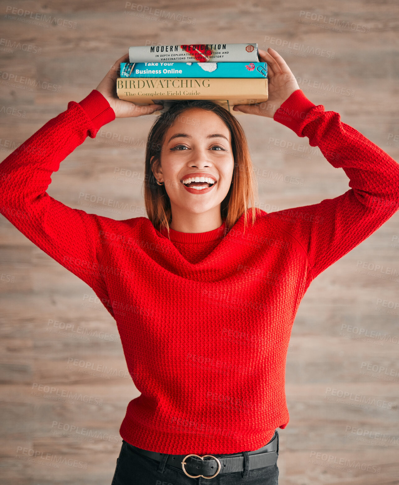 Buy stock photo Reading, student and woman with books on her head while studying in college for a test or exam. Thinking, thoughtful and young female with stories, novels or fiction standing by a wall in the library