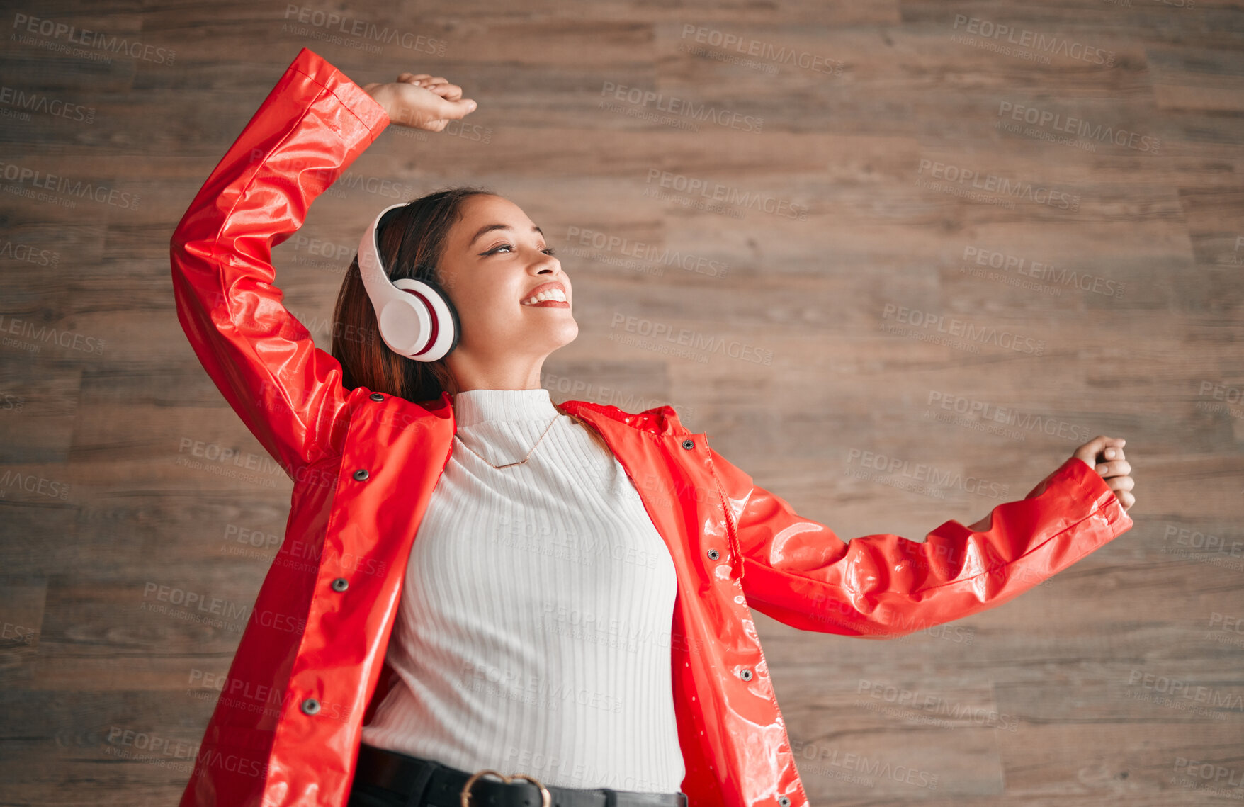 Buy stock photo Woman, happiness and dancing with music headphones isolated on a wood background. Freedom, dance and female or person listening, streaming or enjoying audio, radio song or podcast, sound and smile.