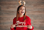 Holiday, happiness and woman laugh with mockup holding merry christmas sign. Wow, excited and isolated happy female with celebration and a smile from winter celebrating and youth with surprise