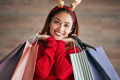Buy stock photo Portrait, christmas headband and female with shopping bags for a festive or holiday celebration. Happy, smile and face of a woman model with gifts or presents with xmas reindeer ears for an event.