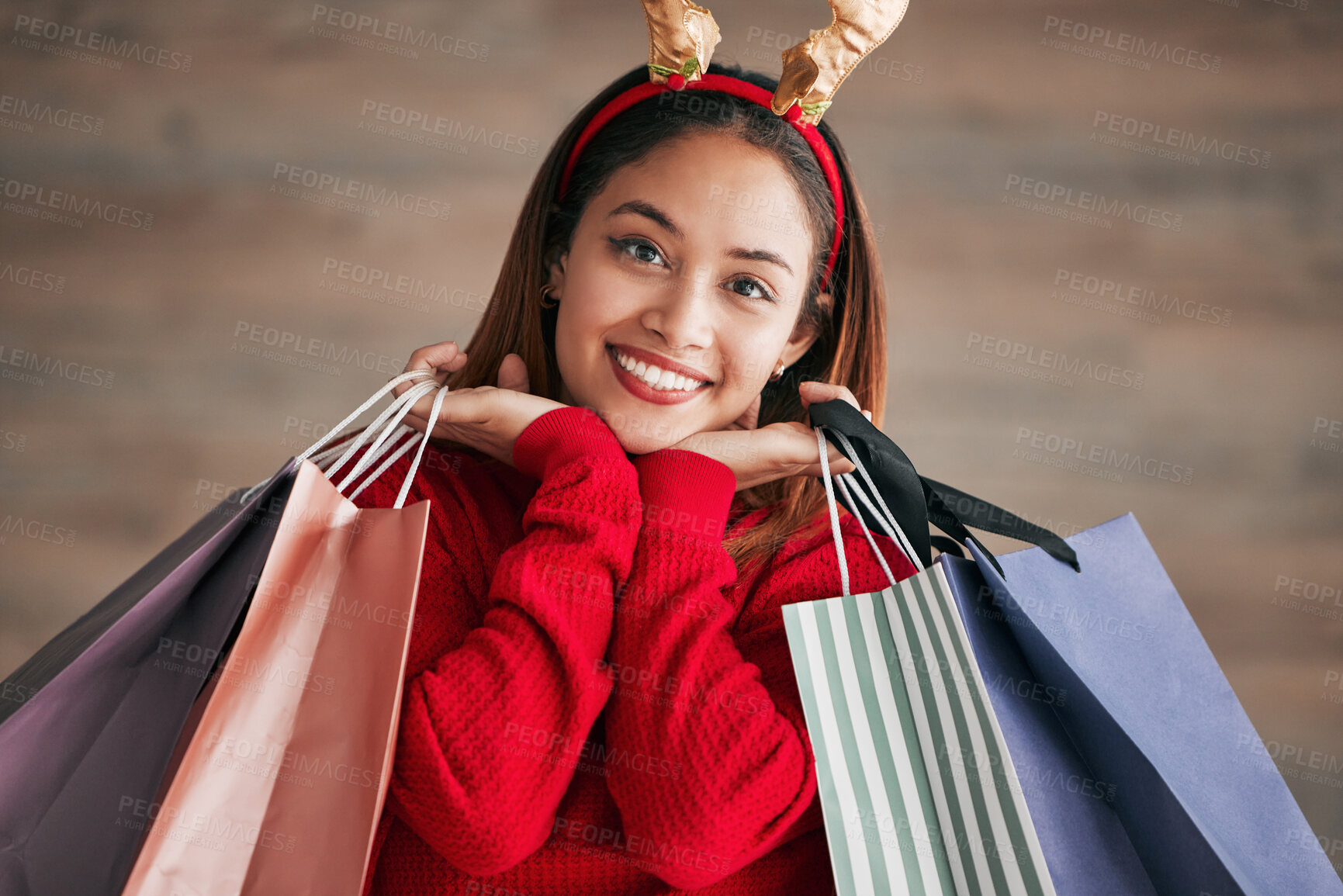 Buy stock photo Portrait, christmas headband and female with shopping bags for a festive or holiday celebration. Happy, smile and face of a woman model with gifts or presents with xmas reindeer ears for an event.