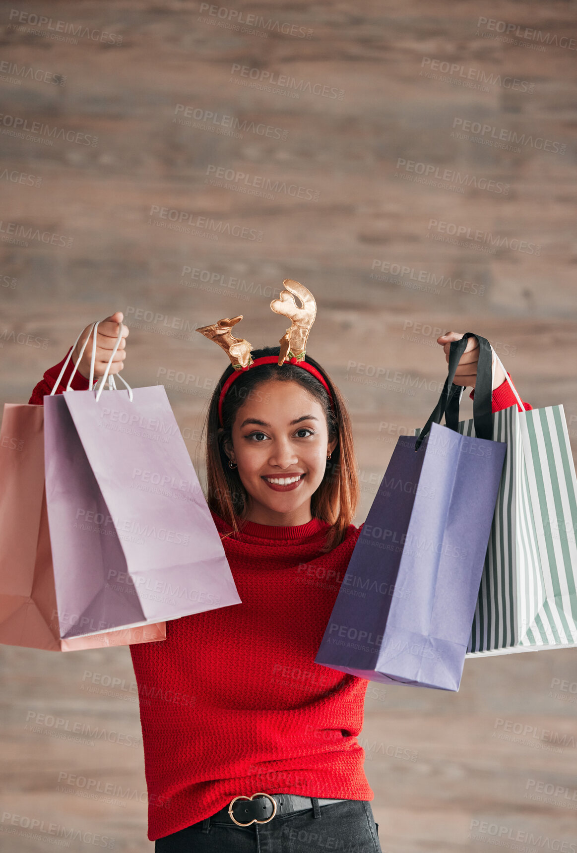 Buy stock photo Shopping bags, happy and female with a christmas headband for a festive or holiday celebration. Happiness, smile and portrait of a woman model with gifts or presents with xmas reindeer ears for event