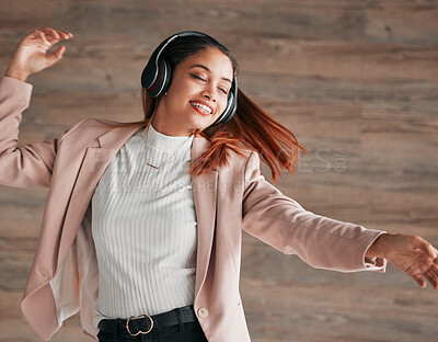 Buy stock photo Dancing, excited and woman streaming to music with happiness or listening to audio online using headphones. Radio, wellness and happy female person dance isolated in a wooden wall background