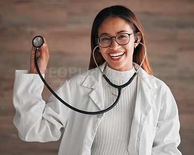 Buy stock photo Healthcare, happy and portrait of a doctor with a stethoscope isolated on a clinic wall. Smile, consulting and a woman in medicine for a consultation, cardiology and medical analysis at a hospital