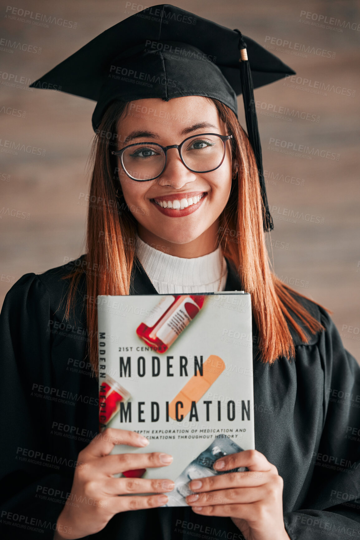 Buy stock photo Doctor graduate, woman portrait and medical textbook of a young student happy from graduation. Learning book, happiness and excited female ready for university education with a smile from knowledge