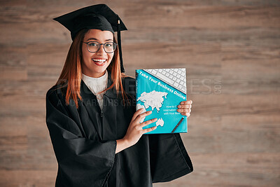 Buy stock photo Graduate, woman portrait and business textbook of a young student happy from graduation. Learning book, happiness and excited female ready for university education with a smile from knowledge