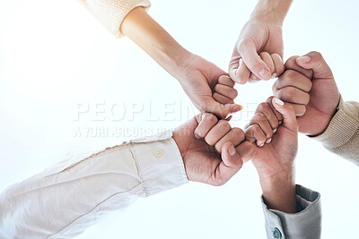 Buy stock photo Below business people, fist bump and circle for team building, support and group goals in workplace. Men, women and teamwork with solidarity for success, motivation and trust with diversity at job