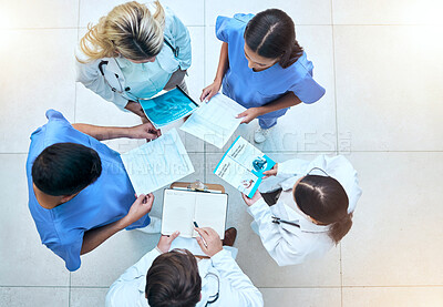 Buy stock photo Doctor, team and documents in collaboration above in healthcare planning, meeting or brainstorming at hospital. Group of medical professionals with paperwork in teamwork, strategy or ideas at clinic